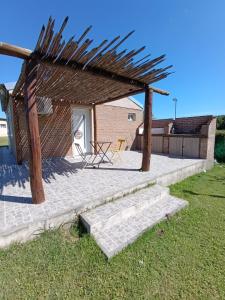 a patio with a wooden pergola and stairs at Casa Quinta en Victoria in Victoria