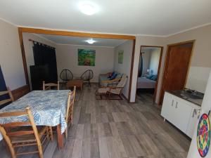 a kitchen and a living room with a table and chairs at Casa Quinta en Victoria in Victoria
