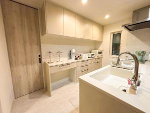 a kitchen with a sink and a counter top at Cozy Stay Pippu in Tōma +60 photos