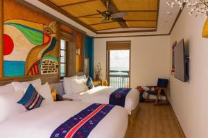 En eller flere senge i et værelse på ZAO Hotel Firework & Sea View