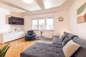 a living room with a couch and a table at Eifel-Lodge Ferienhaus in Mendig