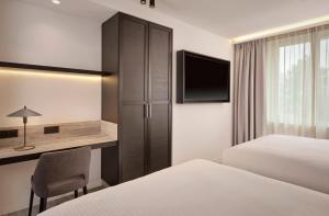 a hotel room with two beds and a desk at Courtyard by Marriott Ghent in Ghent +90 photos