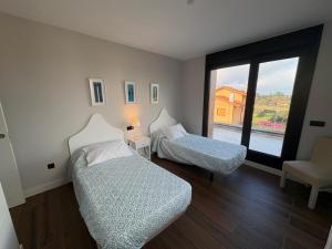 En eller flere senge i et værelse på Chalet La Llavandera