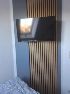a flat screen tv hanging on a wall at Hotel & Restaurant Hasa in Gernrode - Harz +9 photos