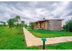 a small house in the middle of a field at Inchorroi Cottages - champagne ridge in Oloyaingalani