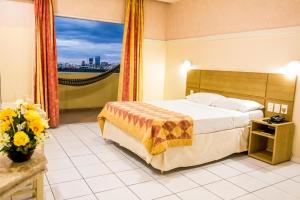 a bedroom with a bed and a large window at Grande Hotel de Juazeiro in Juazeiro +31 photos