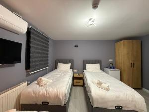 a bedroom with two beds with towels on them at Atay Apart in Istanbul +33 photos