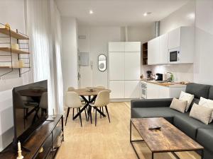 a living room with a couch and a table at TAYP Sol 120 in Seville