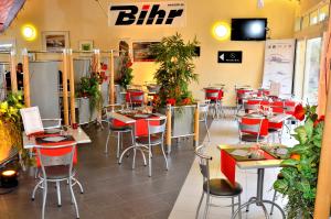 Un restaurante con mesas y sillas en una sala. en LOGIS - Hôtel & Restaurant le Grand Terre, en Chartronges