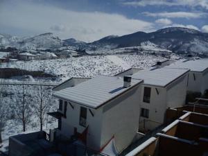 a view of a building with snow on the roof at La Casa del Pianista in Monachil
