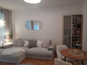 a living room with a couch and a table at Appartment with Spa in Vienna