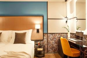 a hotel room with a bed and a desk at Zeus Essence Athens Central, former Athens Key in Athens