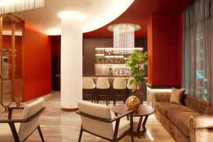 ein Wohnzimmer mit Sofa, Tisch und Stühlen in der Unterkunft Zeus Essence Athens Central, former Athens Key in Athen