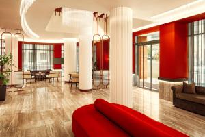 ein Wohnzimmer mit roten Wänden und einer roten Couch in der Unterkunft Zeus Essence Athens Central, former Athens Key in Athen