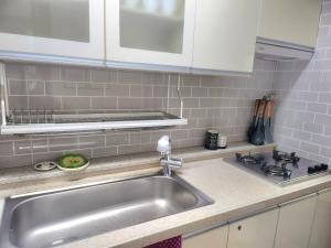 a kitchen with a sink and a counter top at Hanok Story in Jeonju +28 photos