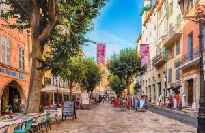 a cobblestone street with tables and chairs in a city at New - Appartement ou Studio Centre Ville Confort in Grasse