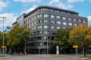 a tall gray building on a city street at SANA Berlin Hotel in Berlin