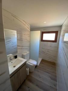 a bathroom with a toilet and a sink at Chalé da Boucinha in Celorico de Basto +13 photos