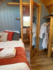 a room with two beds and a closet at Mill House Farm Pods- Jackdaws Den in Pilling