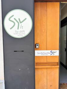 a gray door with a sign on it at SEVILLE YOUR WAY in Seville