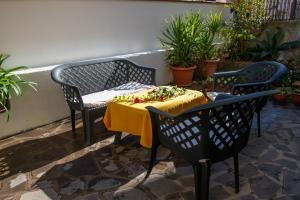 a table with a yellow table cloth on a patio at affittacamere S'Ortensia in Mamoiada +75 photos