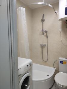 a small bathroom with a shower and a toilet at Laima in Riga