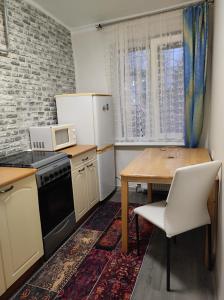 a small kitchen with a table and a microwave at Laima in Riga