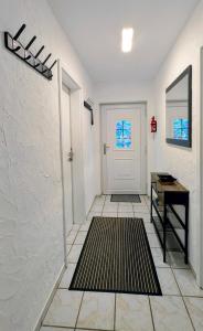 a hallway with a white door and a table at Souterrain Casa Siegburg in Siegburg