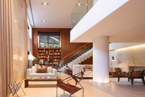 a living room with a staircase in a house at Nomaa Hotel in Curitiba