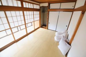 a room with large windows and white furniture at Oharama House in Nasushiobara