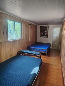 圣格雷戈里奥德波兰科La Costa Homes的有两张床和一扇窗户的房间