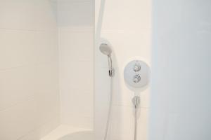 een douche met een douchekop aan de muur bij HofZeit 1 in Mechernich