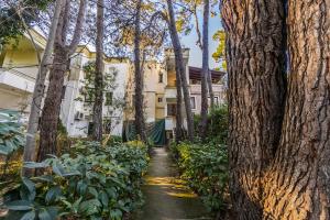 einen Weg durch einen Garten mit Bäumen und Pflanzen in der Unterkunft Pine & Sea Retreat in Golem