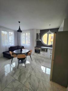 a kitchen and living room with a table and chairs at APart Residence Shumen in Shumen