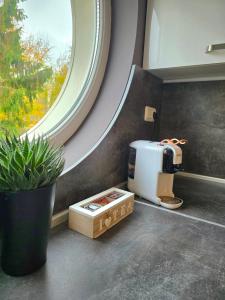 a room with a coffee maker and a window at APart Residence Shumen in Shumen