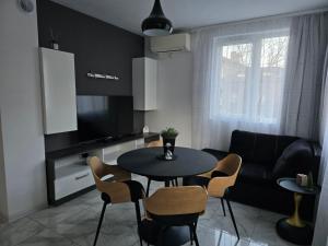 a kitchen and living room with a table and chairs at APart Residence Shumen in Shumen