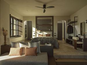 a living room with two beds and a couch at Oreno Mountain Retreat Hotel in Tsepelovo