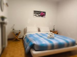 a teddy bear sitting on a bed in a bedroom at B&B dei nonni in Maranello