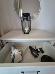 a shelf with a mirror and a vase on it at Spacious modern 1-bed apartment near Victoria Park & London Stadium in London +13 photos