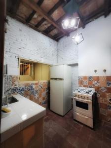 a kitchen with a stove and a white refrigerator at Cómo en casa, cerca de todo, amplio 100m2 in San Miguel de Tucumán +3 photos
