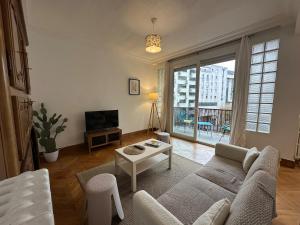 a living room with a couch and a table at Le TNB Rennes in Rennes