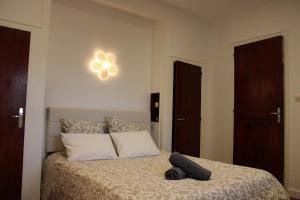 a bedroom with a bed with a black object on it at Le TNB Rennes in Rennes