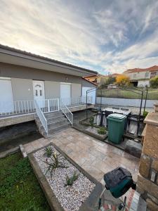 a patio with a table and a trash can at Bungalow By Eftimiya in Nea Roda