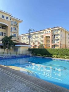 a large swimming pool in front of a building at EasyStay Condo Davao in Davao City