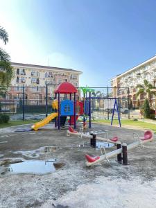 a park with a playground with a slide at EasyStay Condo Davao in Davao City