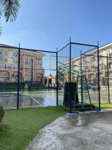 a batting cage with a playground in front of a building at EasyStay Condo Davao in Davao City