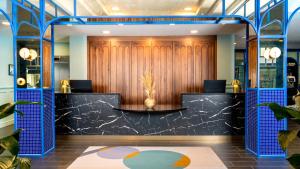 a lobby with a wood paneled wall and a desk at Temple Bar Hotel Dublin by The Unlimited Collection in Dublin