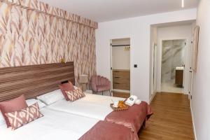 En eller flere senge i et værelse på TURISCAPITAL Plaza de BALTAR