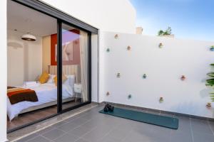 a bedroom with a bed and a large glass window at Bright Modern Studio, Gauthier in Casablanca