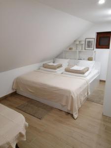 a white bedroom with a large bed in a room at Noel in Vukovar +38 photos